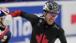 Canada's William Dandjinou celebrates after winning the gold medal in the men's 1000 meters final of the ISU Short Track World Tour and Olympics Milano-Cortina 2026 test event, in Milan, Italy, Sunday, Feb. 16, 2025. (Luca Bruno/AP)