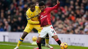 Manchester United's Amad Diallo, right, is challenged by Crystal Palace's Tyrick Mitchell during the English Premier League soccer match between Manchester United and Crystal Palace at Old Trafford stadium in Manchester, England, Sunday, Feb. 2, 2025. (Dave Thompson/AP)