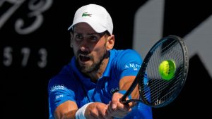 Novak Djokovic of Serbia plays a backhand return to Alexander Zverev of Germany during their semifinal match at the Australian Open tennis championship in Melbourne, Australia, Friday, Jan. 24, 2025. (Manish Swarup/AP)