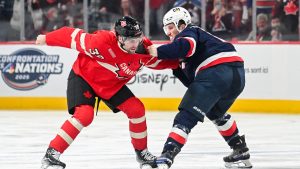 Canada's Brandon Hagel (38) fights with United States' Matthew Tkachuk (19) during first period 4 Nations Face-Off hockey action in Montreal, Saturday, February 15, 2025. (Graham Hughes/THE CANADIAN PRESS)