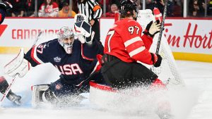 Canada's Connor McDavid (97) scores on United States goaltender Connor Hellebuyck (37) during first period 4 Nations Face-Off hockey action in Montreal, Saturday, February 15, 2025. (Graham Hughes/CP)