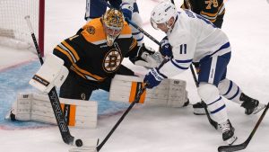 Boston Bruins goaltender Jeremy Swayman (1) makes a save on a shot by Toronto Maple Leafs center Max Domi (11) during the first period of an NHL hockey game, Tuesday, Feb. 25, 2025, in Boston. (Charles Krupa/AP Photo)