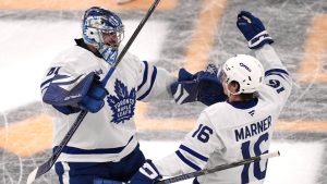 Toronto Maple Leafs right wing Mitch Marner (16) celebrates after his game-winning goal with goaltender Anthony Stolarz (41) following an overtime period of an NHL hockey game against the Boston Bruins, Tuesday, Feb. 25, 2025, in Boston. (Charles Krupa/AP Photo)