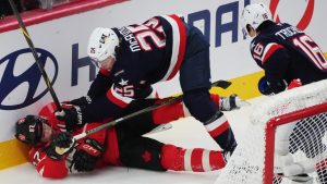 Canada's Sidney Crosby (87) is checked by United States' Charlie McAvoy (25) as Vincent Trocheck (16) looks on during first period 4 Nations Face-Off hockey action in Montreal on Saturday, Feb. 15, 2025. (Christinne Muschi/CP)