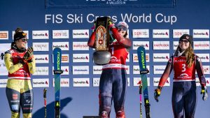 Second placed Daniela Maier of Germany, left, the winner Marielle Thompson of Canada, centre, third place India Sherret of Canada, right, celebrate on the podium of the women's Ski Cross event at the FIS Ski Cross, SX, World Cup, in Veysonnaz, Switzerland, Saturday, Feb. 1, 2025. (Jean-Christophe Bott/Keystone via AP)