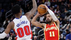 Atlanta Hawks guard Trae Young (11) looks to pass the ball against Detroit Pistons forward Ronald Holland II (00) during the first half of an NBA basketball game Monday, Feb. 3, 2025, in Detroit. (Duane Burleson/AP)