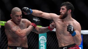 Alex Pereira, left, fights Magomed Ankalaev during a UFC 313 mixed martial arts light heavyweight title bout Saturday, March 8, 2025, in Las Vegas. (John Locher/AP)