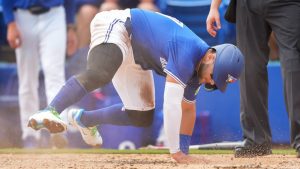 Toronto Blue Jays shortstop Bo Bichette slides safe at home plate to score a run against the New York Yankees during third inning Grapefruit League MLB baseball action in Dunedin Fla., on Saturday, February 22, 2025. (Nathan Denette/CP)