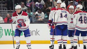 Montreal Canadiens right wing Patrik Laine, left, goes to the bench to celebrate his goal against the Seattle Kraken during the second period of an NHL hockey game Wednesday, March 12, 2025, in Seattle. (Lindsey Wasson/AP)