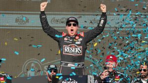 Christopher Bell celebrates after winning a NASCAR Cup Series auto race at Phoenix Raceway. (Darryl Webb/AP)