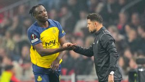 Union SG's Promise David, left, celebrates with Union SG's head coach Sebastien Pocognoli after scoring his side's second goal during the Europa League play-off soccer match between Ajax and Union Saint-Gilloise at the Johan Cruyff ArenA in Amsterdam, Netherlands, Thursday, Feb. 20, 2025. (Peter Dejong/AP)