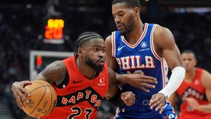 Toronto Raptors guard Jamal Shead (23) drives past Philadelphia 76ers guard Jared Butler (12) during first half NBA basketball action in Toronto, Wednesday, March 12, 2025. THE CANADIAN PRESS/Frank Gunn