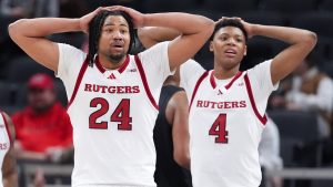 Rutgers center Lathan Sommerville (24) and Ace Bailey (4) watch against Southern California during the second half of an NCAA college basketball game in the first round of the Big Ten Conference tournament in Indianapolis, Wednesday, March 12, 2025. (AP Photo/Michael Conroy)