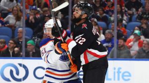 Edmonton Oilers defenceman Troy Stecher (51) and Buffalo Sabres left wing Jordan Greenway (12) battle for position during the first period of an NHL hockey game Monday, March 10, 2025, in Buffalo, N.Y. (Jeffrey T. Barnes/AP)