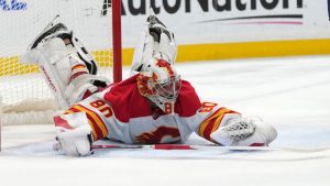 Calgary Flames goaltender Dan Vladar falls to the ice as he defends the goal during the second period of an NHL hockey game against the Florida Panthers, Saturday, March 1, 2025, in Sunrise, Fla. (Lynne Sladky/AP)