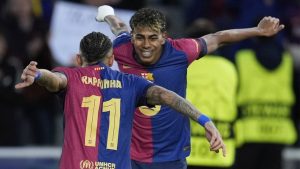 Barcelona's Raphinha, left, celebrates with his teammate Lamine Yamal after scoring his side's opening goal during the Champions League round of 16 second leg soccer match between FC Barcelona and SL Benfica at the Lluis Companys Olympic Stadium in Barcelona, Spain, Tuesday, March 11, 2025. (Emilio Morenatti/AP)
