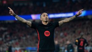 Barcelona's Raphinha celebrates after scoring his side's opening goal during the Champions League round of 16 first leg soccer match between SL Benfica and FC Barcelona at the Luz stadium in Lisbon, Wednesday, March 5, 2025. (Armando Franca/AP)